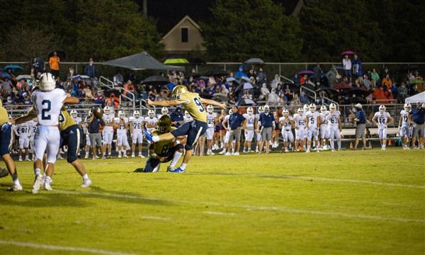 Independence High football player kicks ball